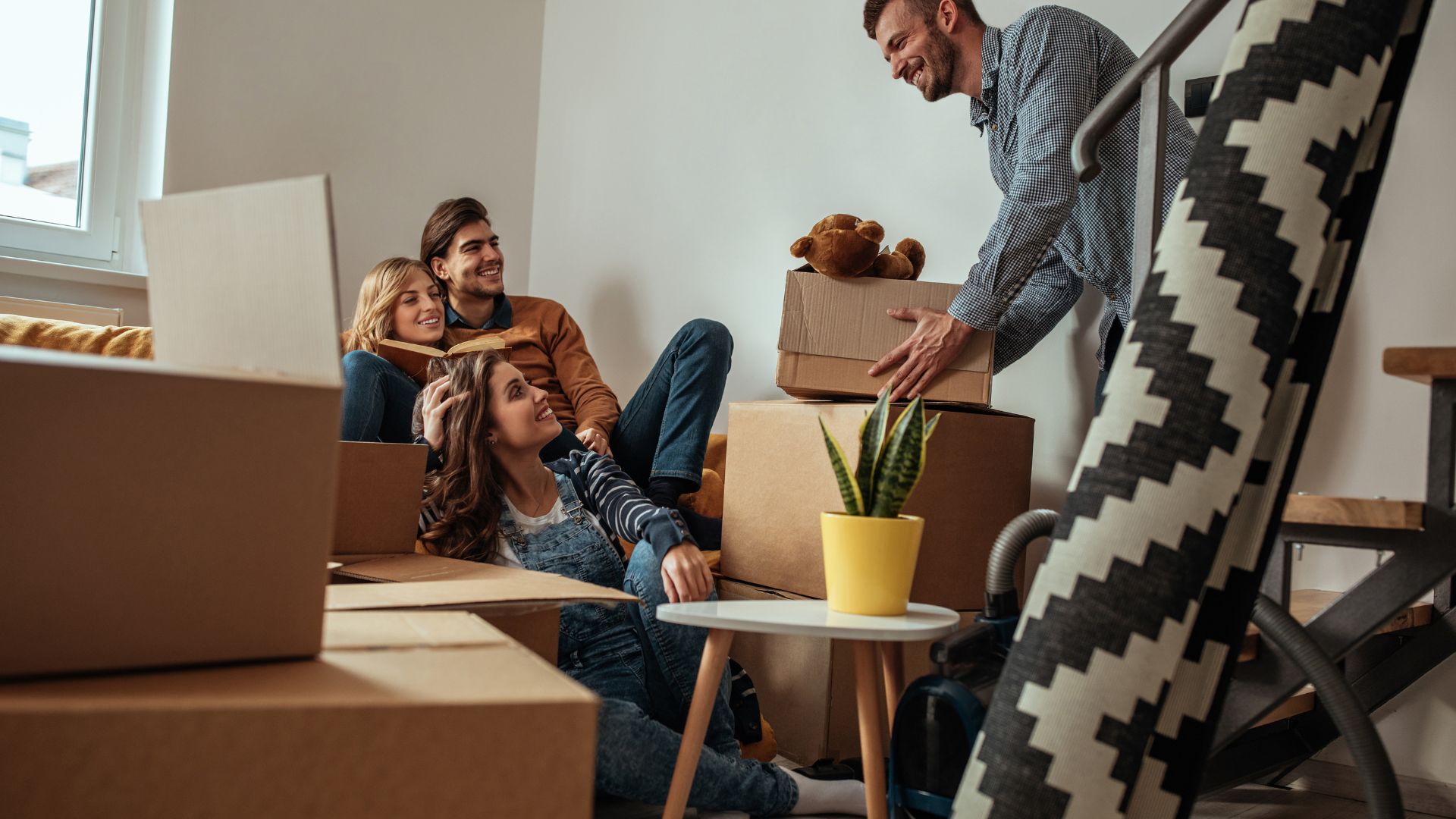 Image of a family surrounded by boxes, smiling