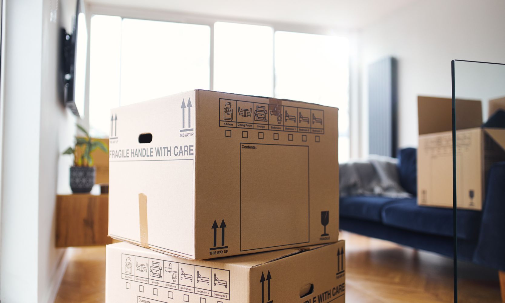 Image of boxes stacked on each other inside of an apartment