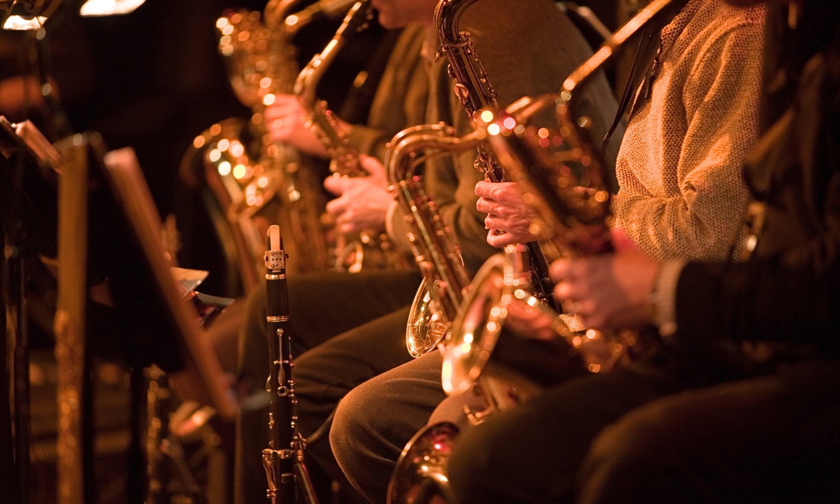 Close up image of a live jazz band featuring saxophone musicians