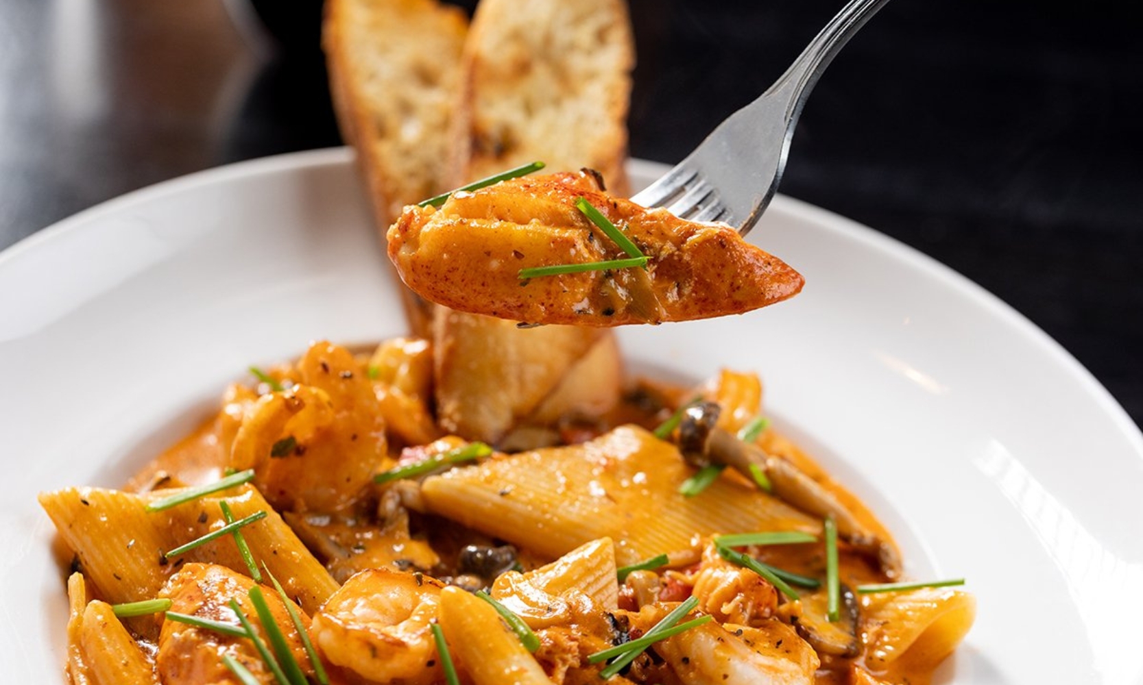 Closeup image of a lobster pasta entree at fire + wine in Glen Ellyn, IL