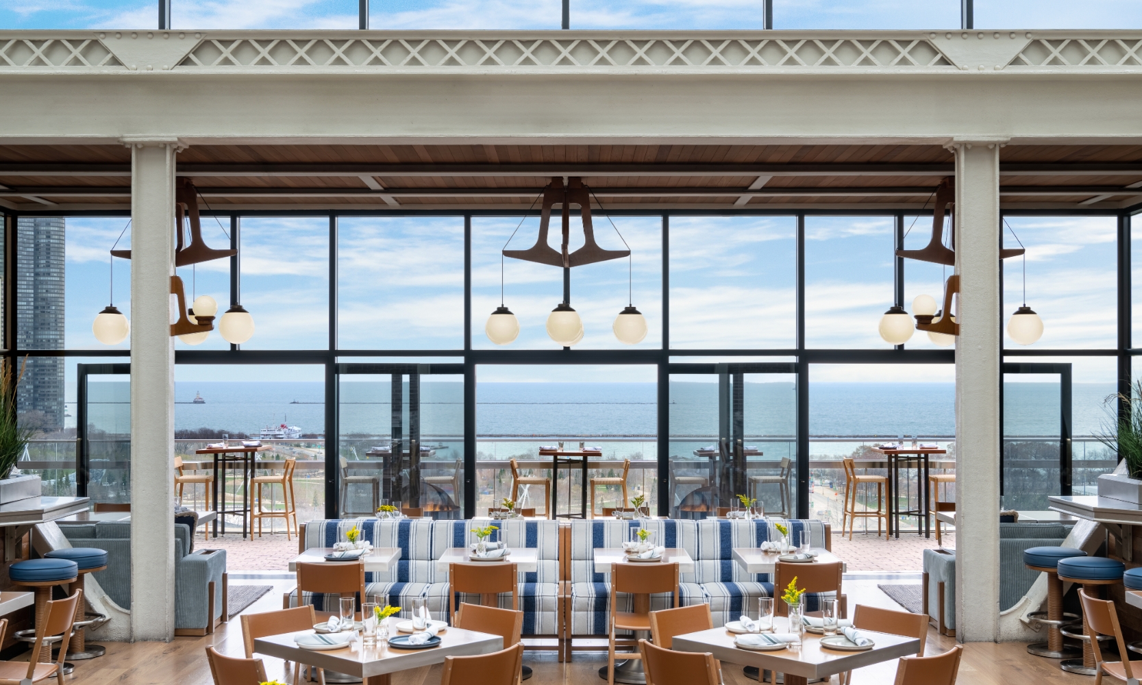 Interior image of Cindy's rooftop restaurant in River North Chicago with high glass windows and Lake Michigan in the background