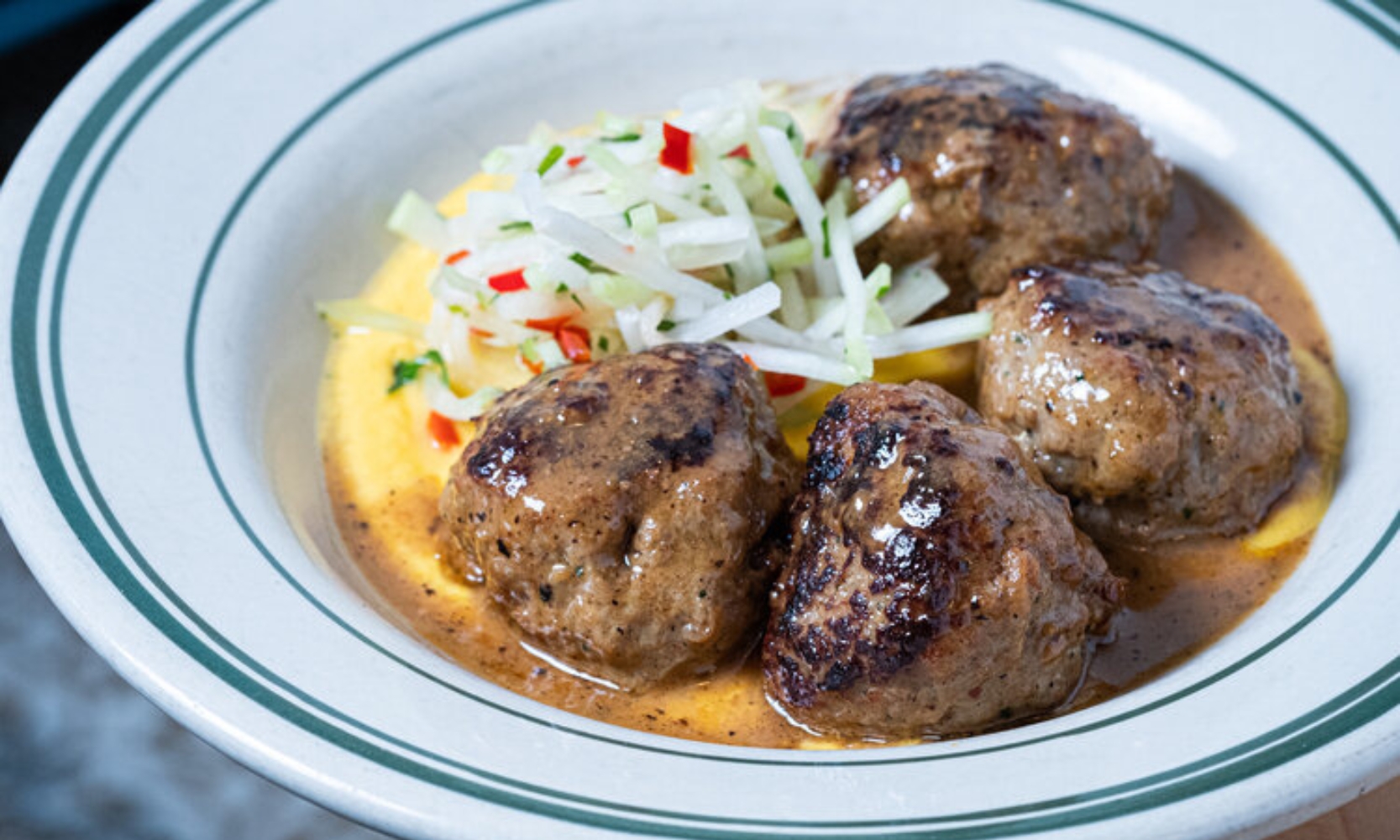 Closeup image of a meatball entree at mfk. Restaurant in Lakeview, Chicago