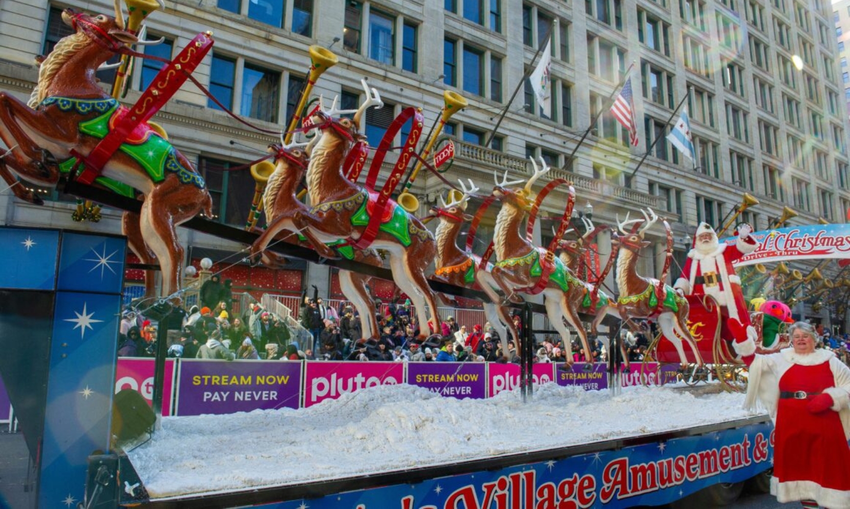 An image of a Christmas holiday float at the Chicago Thanksgiving Parade with Santa and reindeer