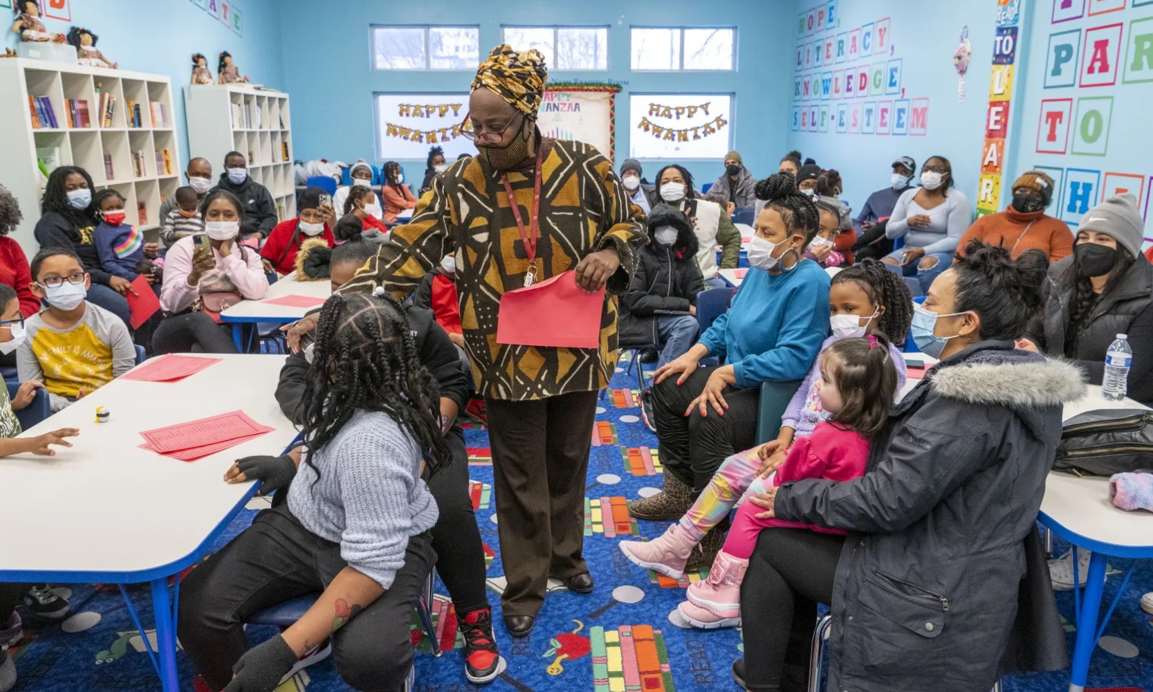 A group of children celebrating Kwanzaa at the Bronzeville Children's Museum in Chicago and craftmaking