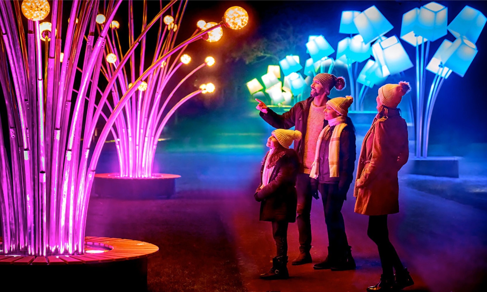 A family looking at lighting installations at the Chicago Botanic Garden Lightscape