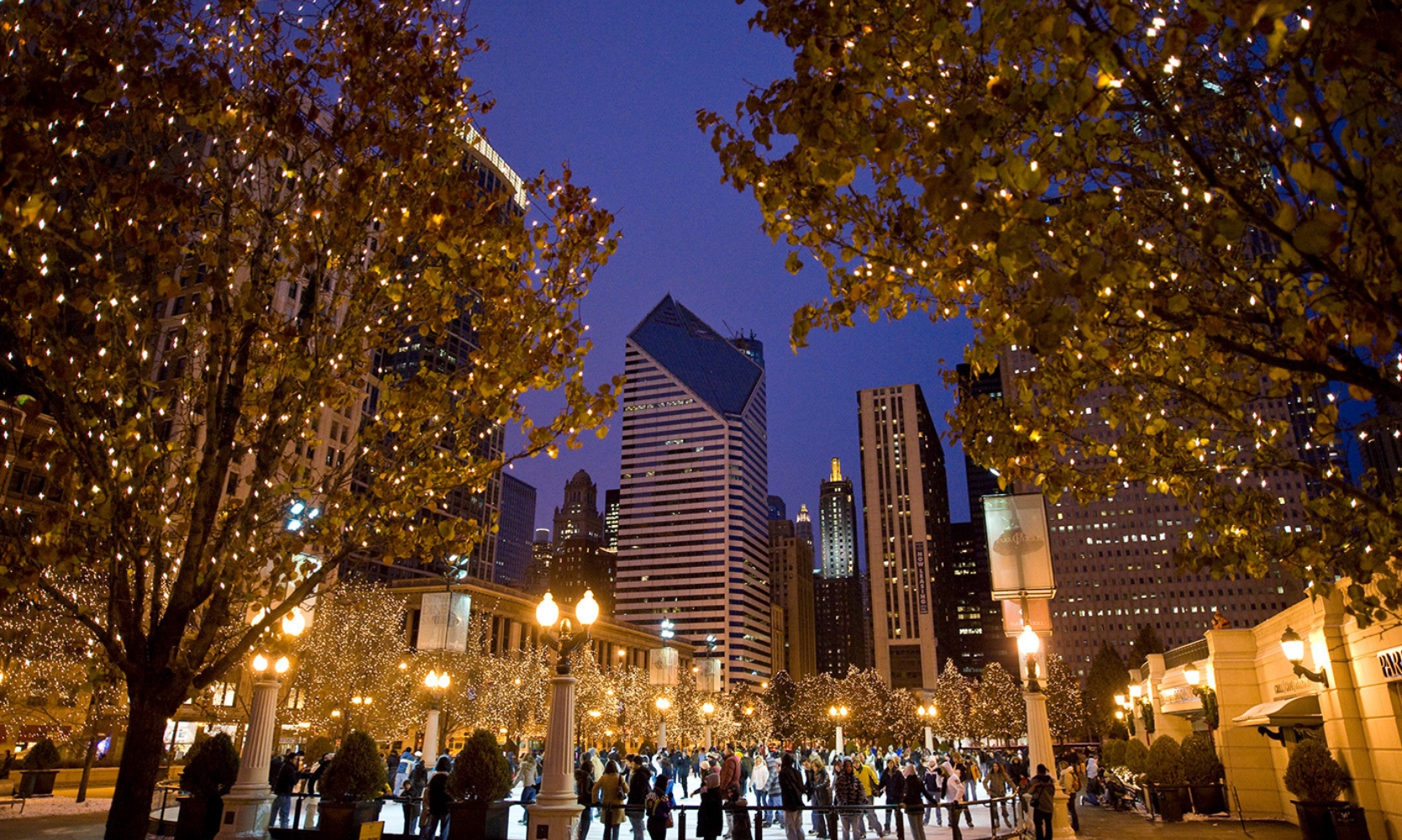 People ice skating at the McCormick Tribune Plaza in Chicago at night