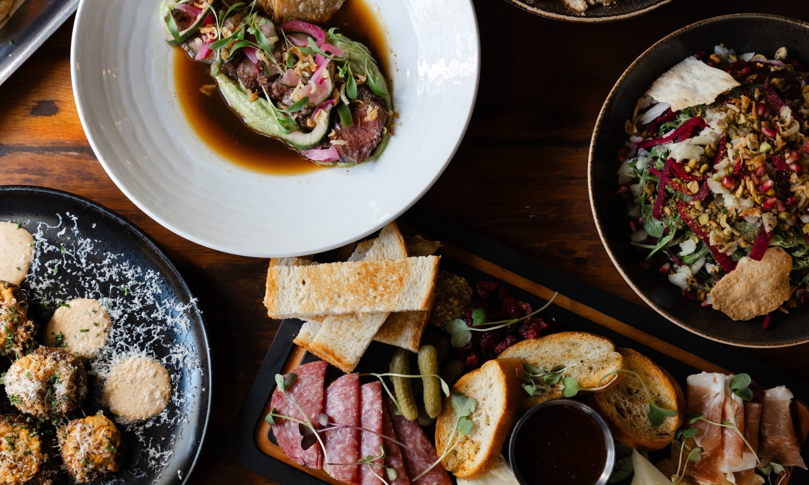 Top view flat lay image of multiple dishes at barrel + rye restaurant in Geneva, IL