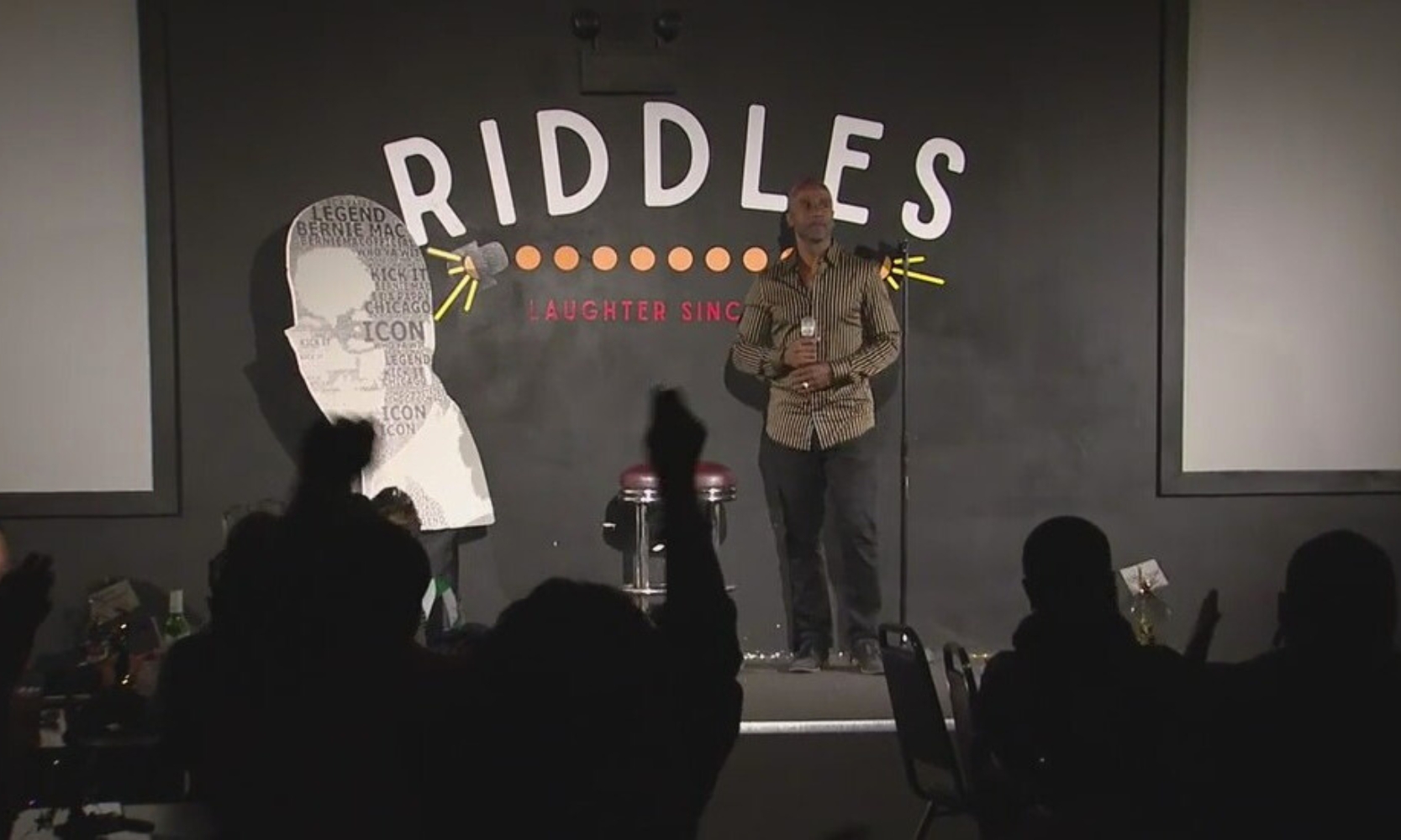 Image of a person doing stand up in honor of Bernie Mac at the Riddles Comedy Club in Alsip, IL