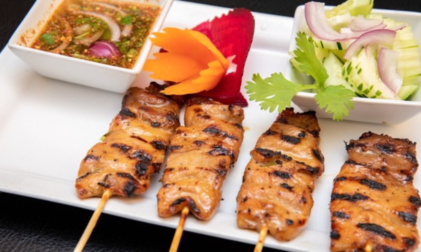 Image of a charred pork skewer entree at altThai restaurant in Arlington Heights, IL