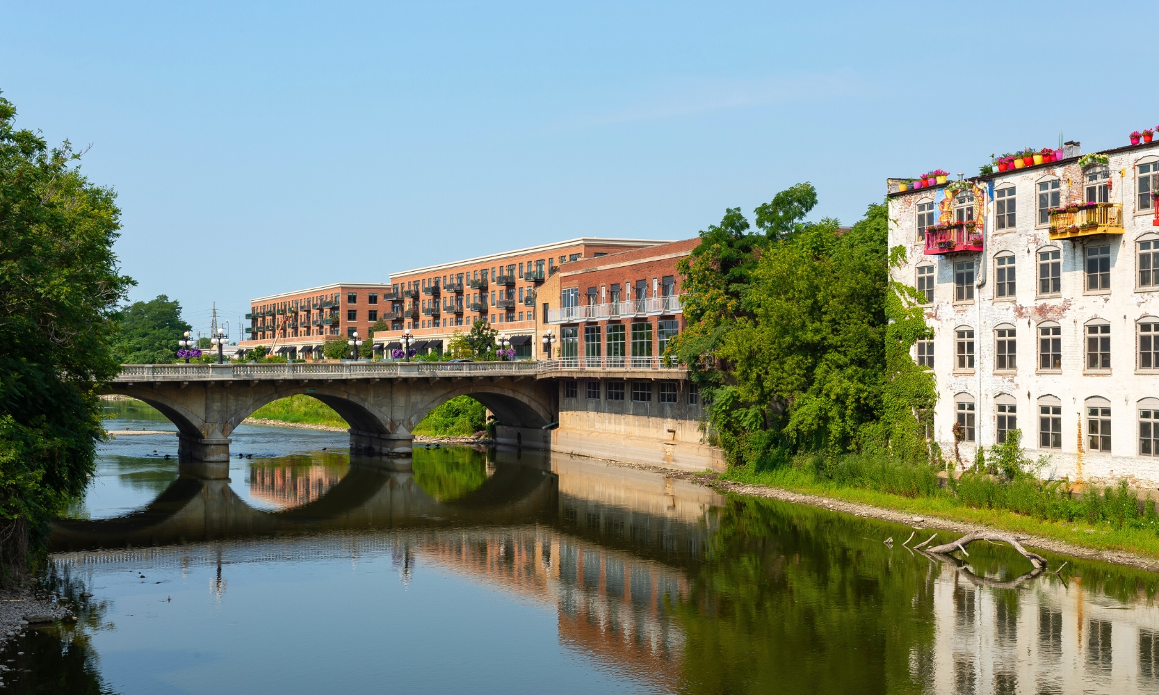 Image of residential buildings overlooking a body of water with a bridge in St. Charles, IL