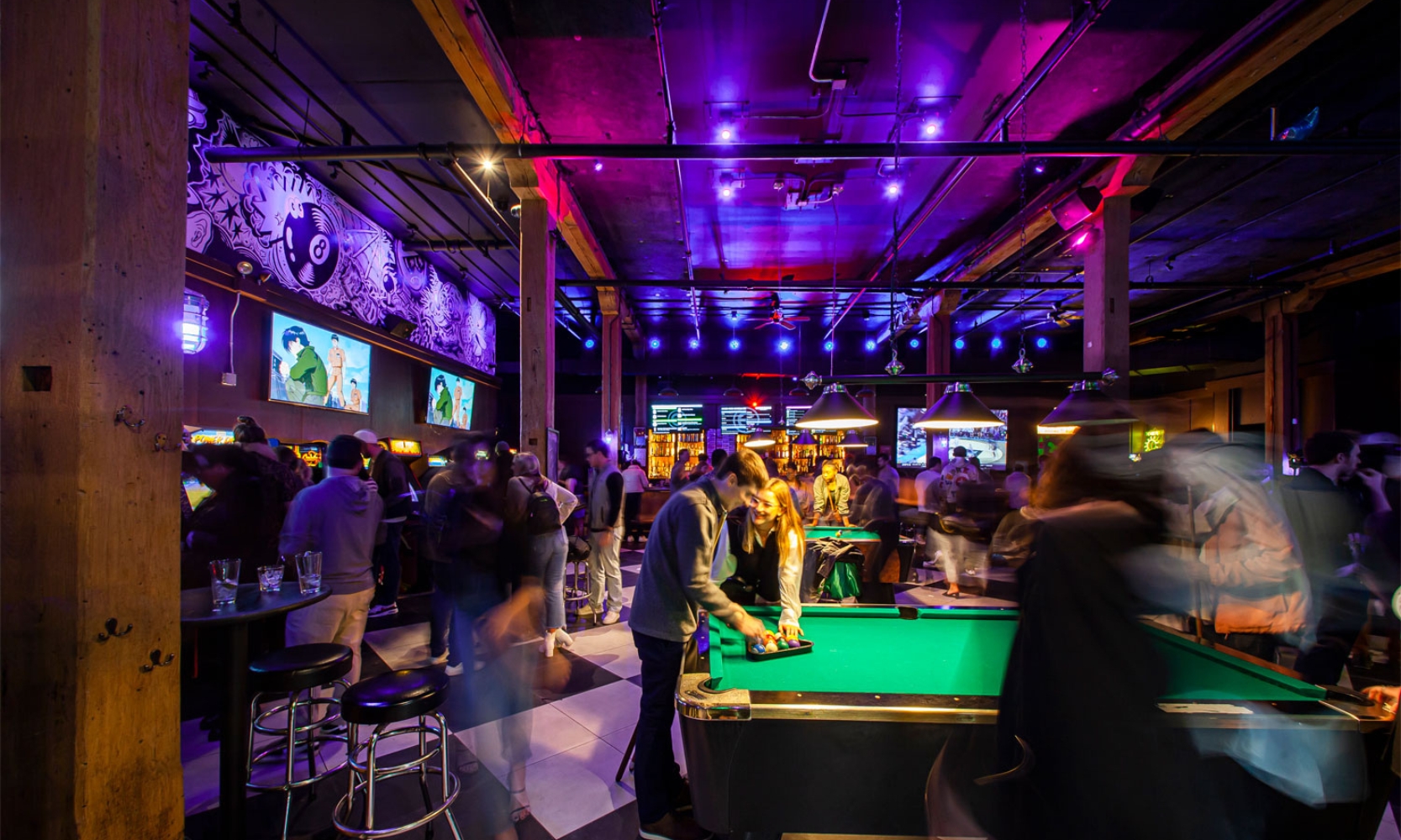 Interior image of the Emporium arcade bar with people playing pool at Fulton Market District Chicago