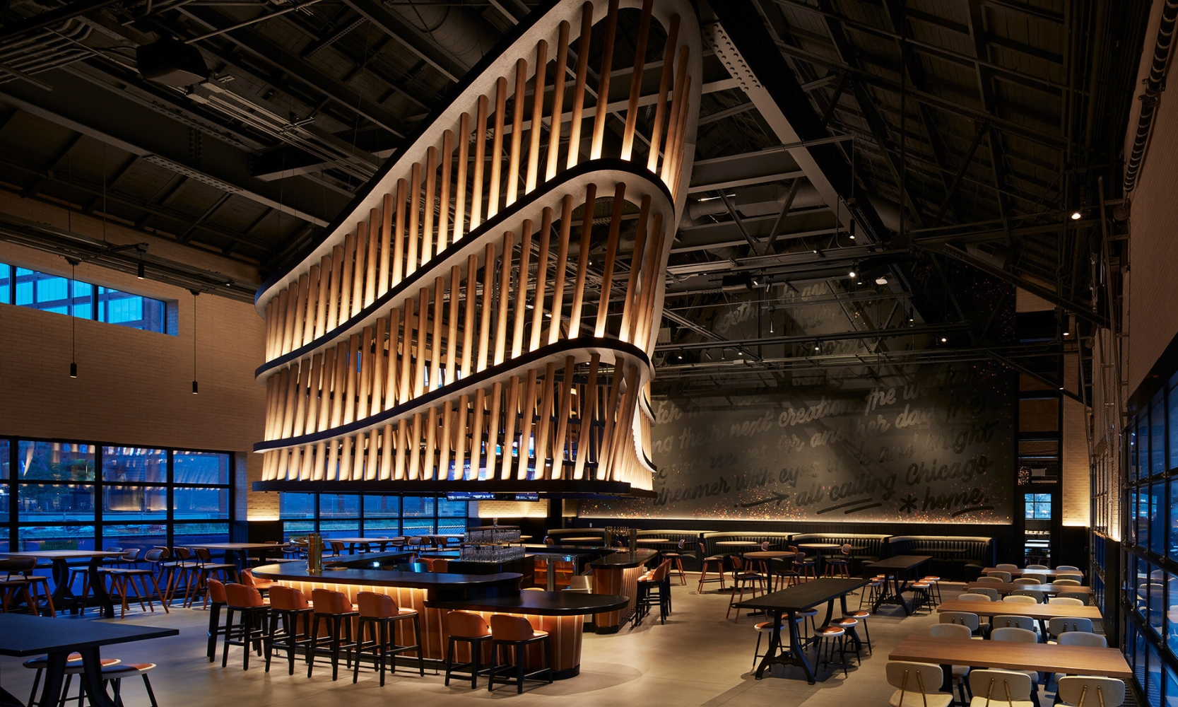 Interior image of an empty Guinness Open Gate Brewery Chicago with a massive lighting sculpture over chairs