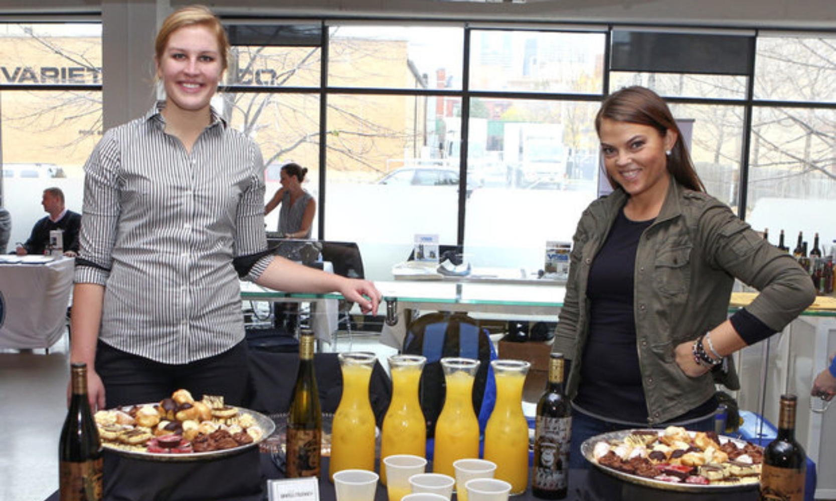 Image of two vendors serving champaign and charcuterie at Taste of Fulton in Fulton Market District