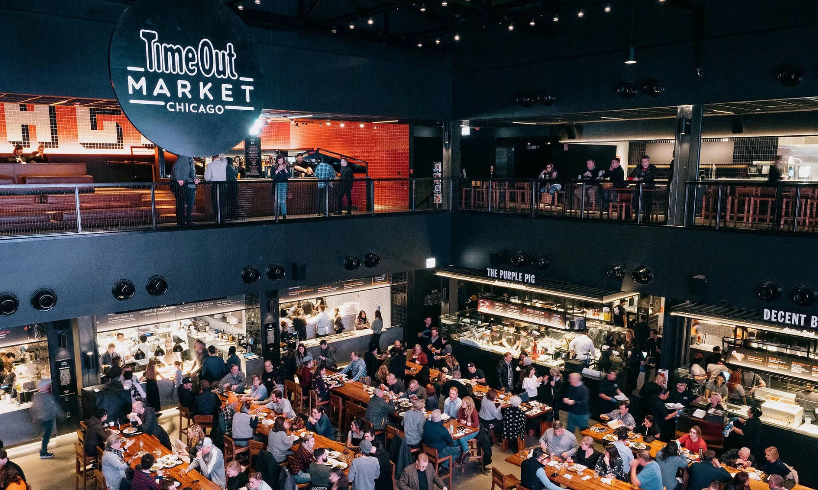 Top-view image of the Time Out Market Chicago food court with people eating at Fulton Market District