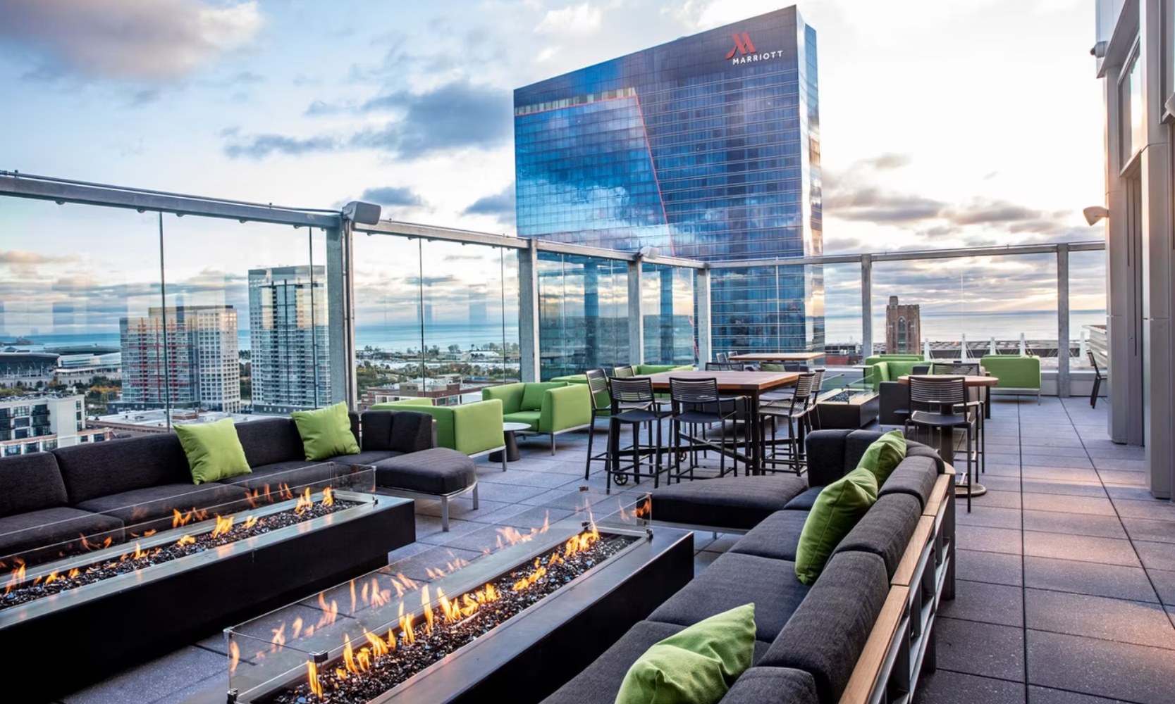 Exterior image of VU Rooftop Bar's rooftop with an outdoor fireplace overlooking the Marriott Hotel and Lake Michigan in Chicago
