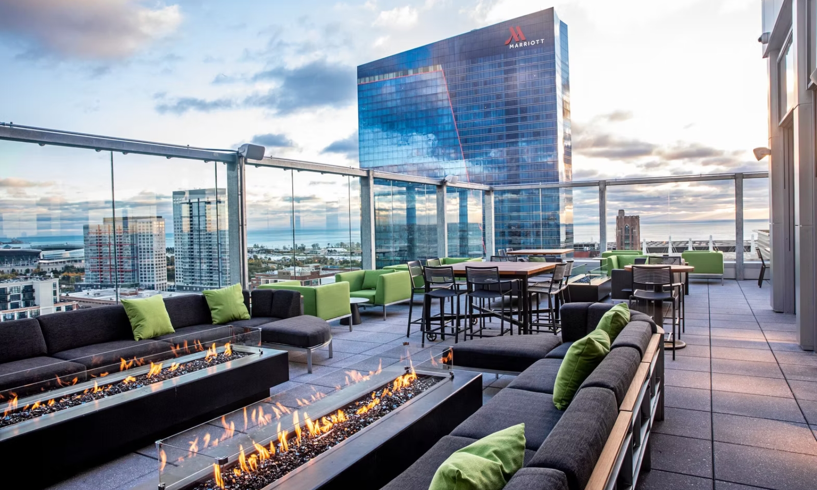Image of the VU Rooftop's rooftop terrace with a fire pit, chairs, and skyscraper views in Chicago