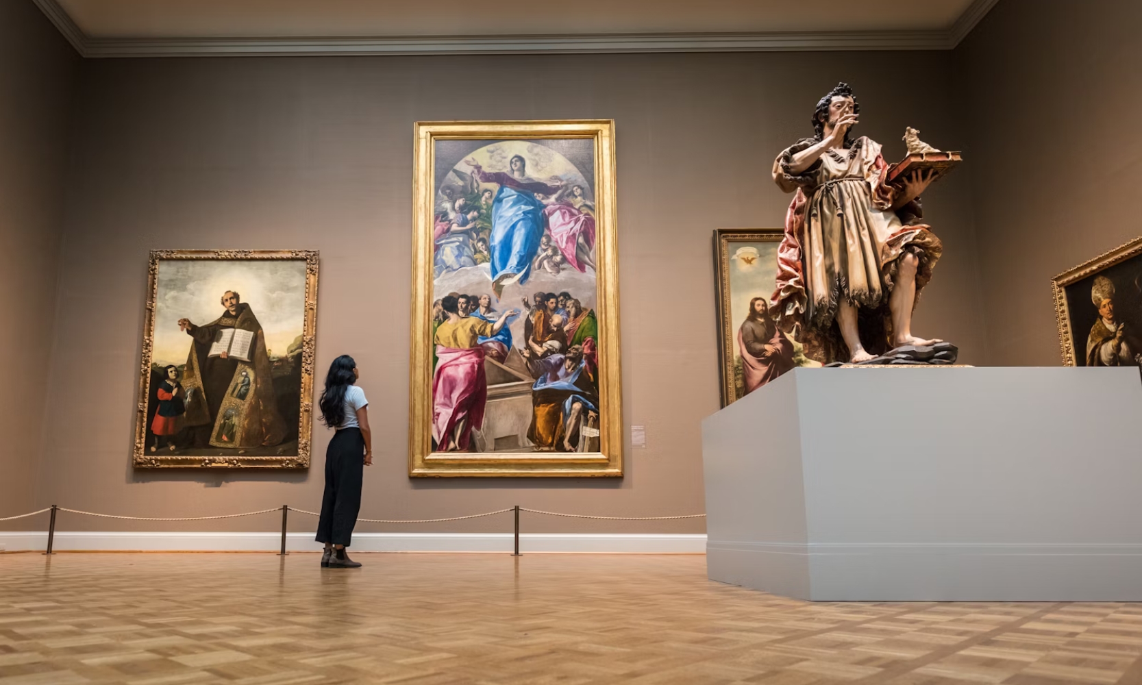 Interior image of a woman looking at displayed art at the Art Institute of Chicago