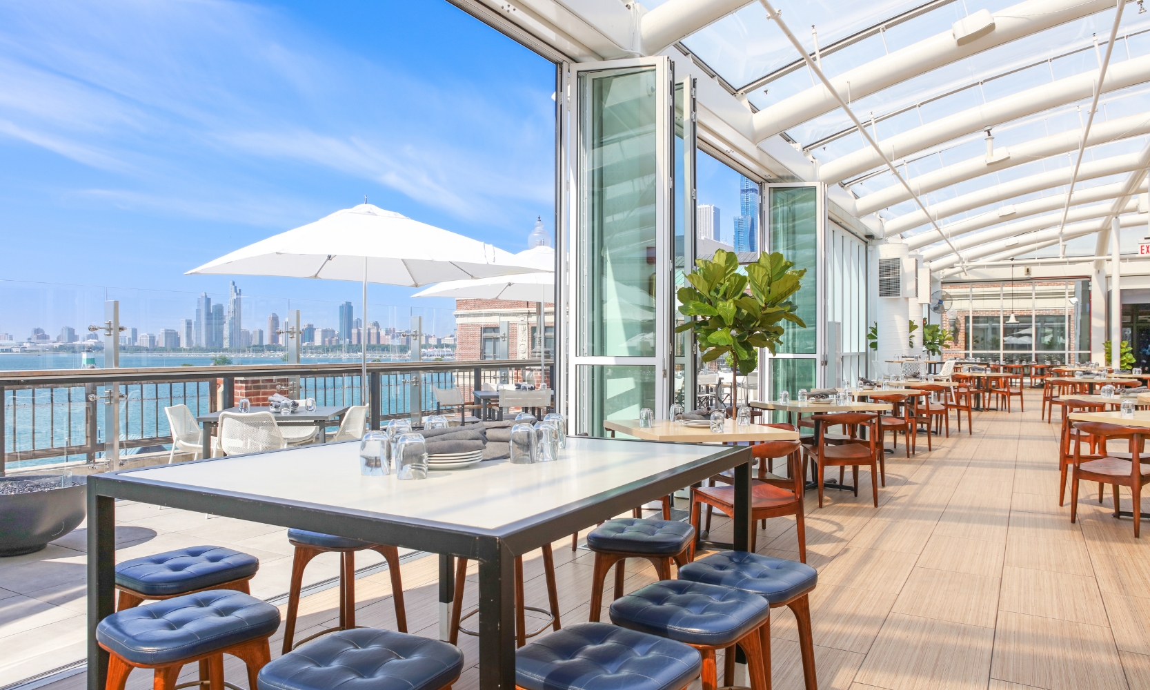 Interior image of Offshore Rooftop during the day overlooking the patio and Chicago skyline