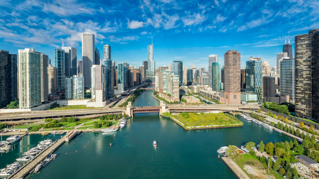 Wide-view image of Chicago skyscrapers with a waterfront lake