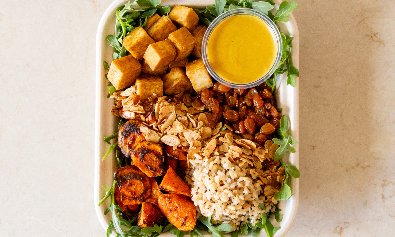 Close-up top-view image of a curry tofu bowl at PICNIC in Evanston, IL