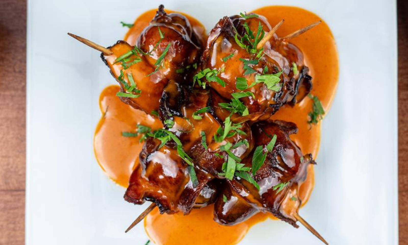 Close-up top-view image of a bacon-wrapped dates dish at Tapas Barcelona in Evanston, IL