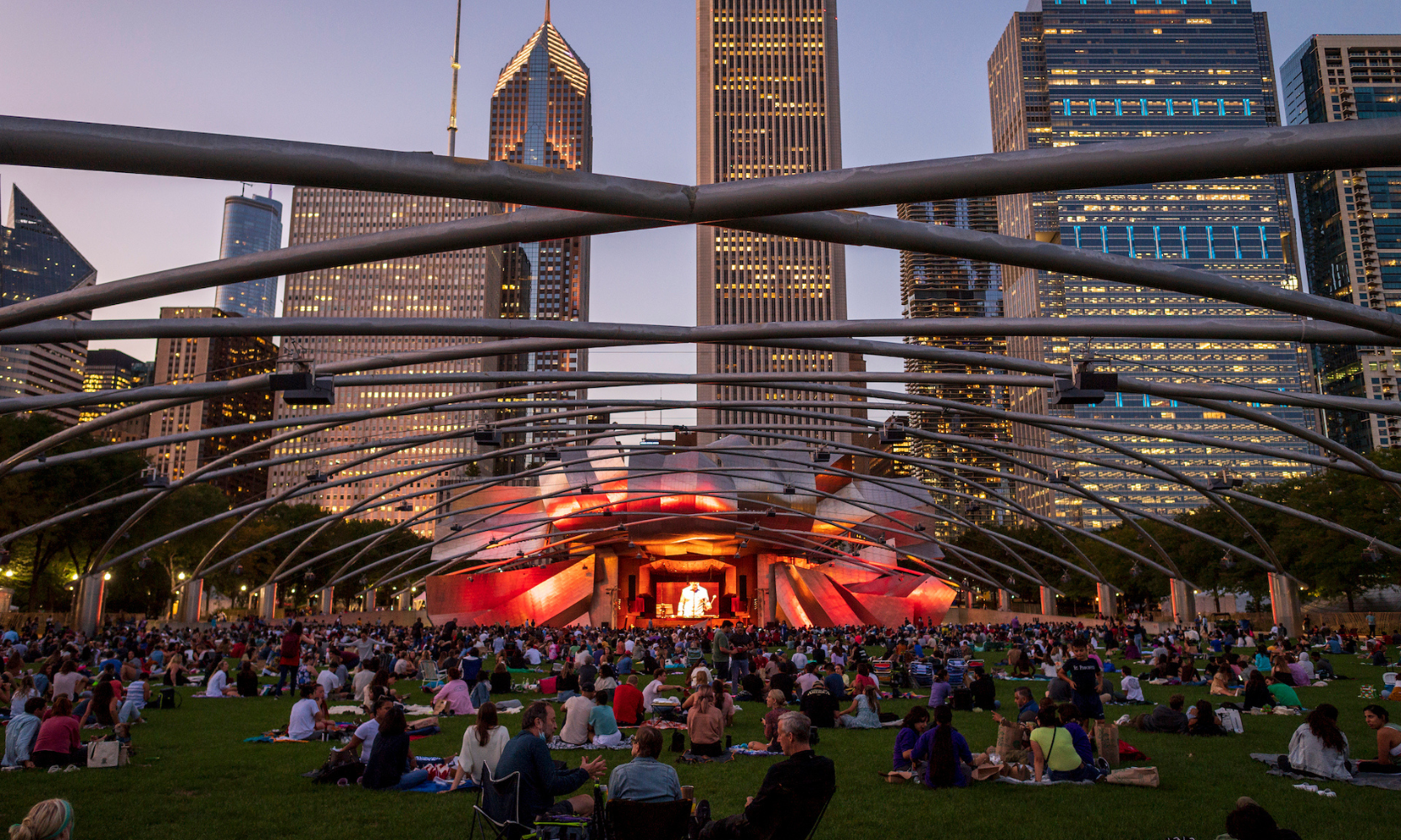 Rear-view image of a crowd at the Millennium Park Summer Music Series at sundown