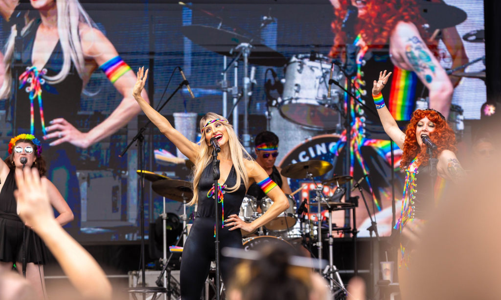 Image of a band performing in rainbow accessories on stage at the Northalsted Market Days festival in Chicago